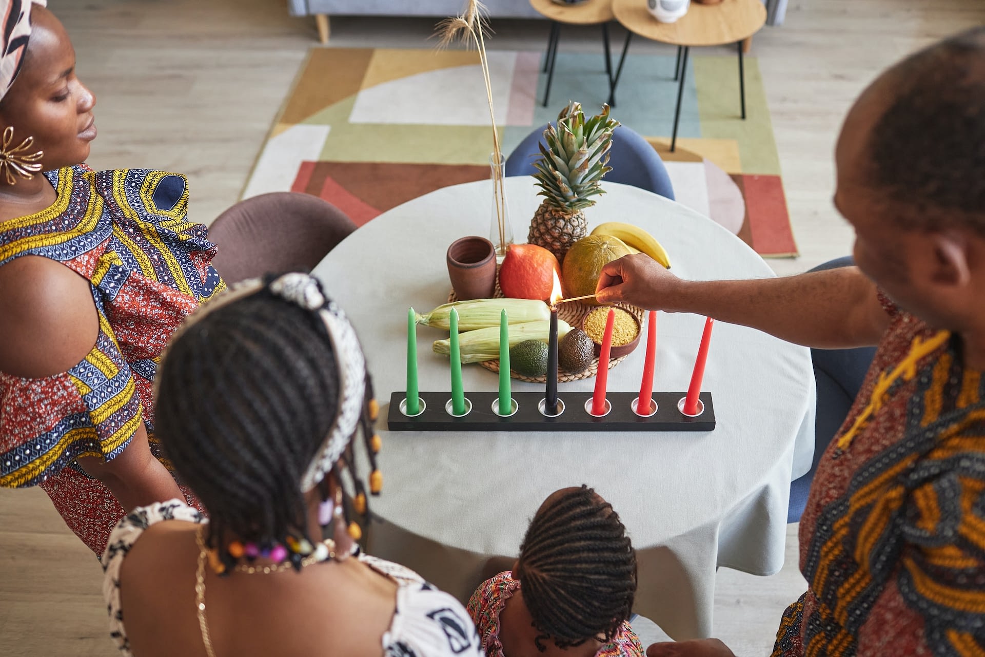 african family celebrating kwanzaa holiday at home