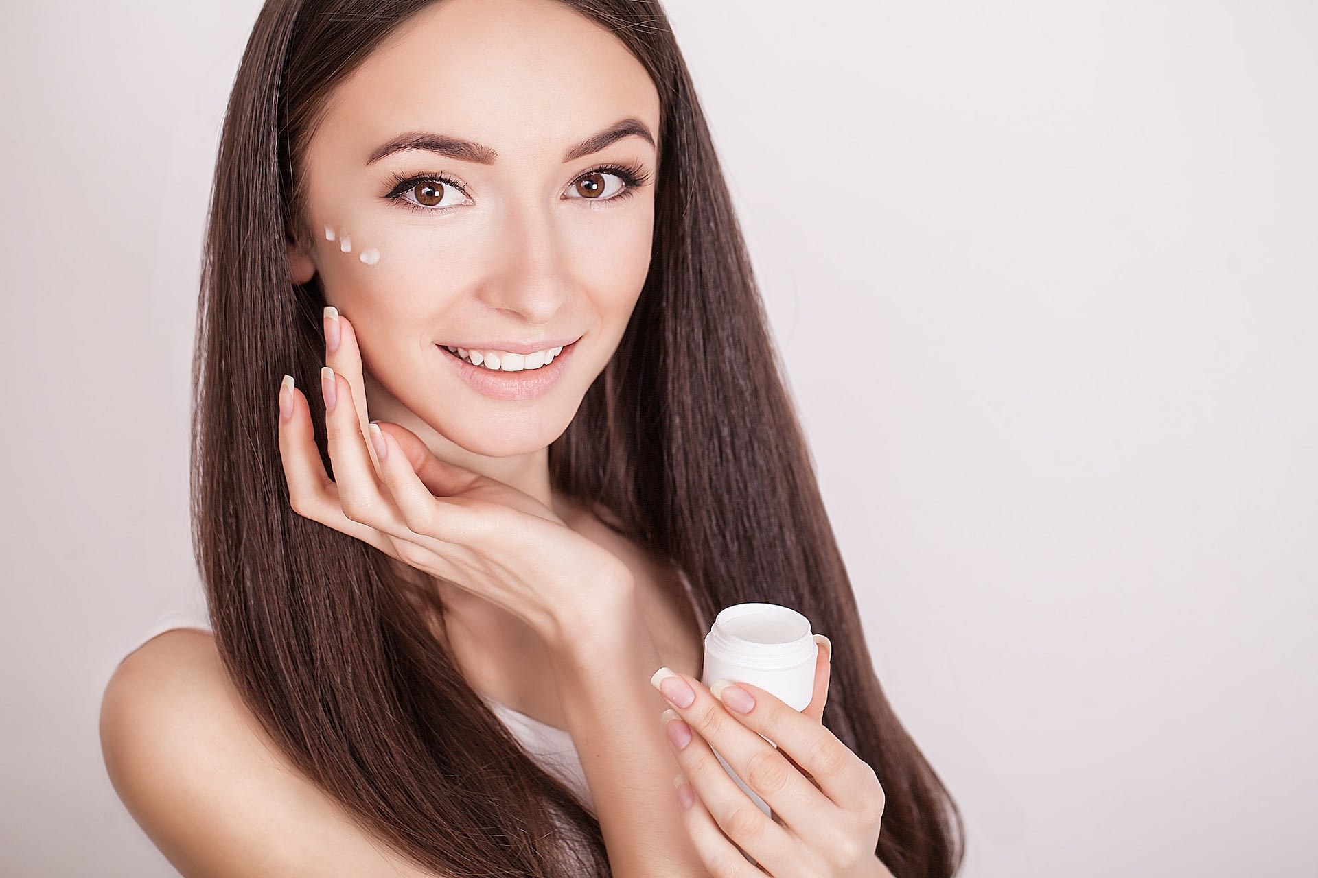 beautiful healthy young woman with long hair caring for their skin