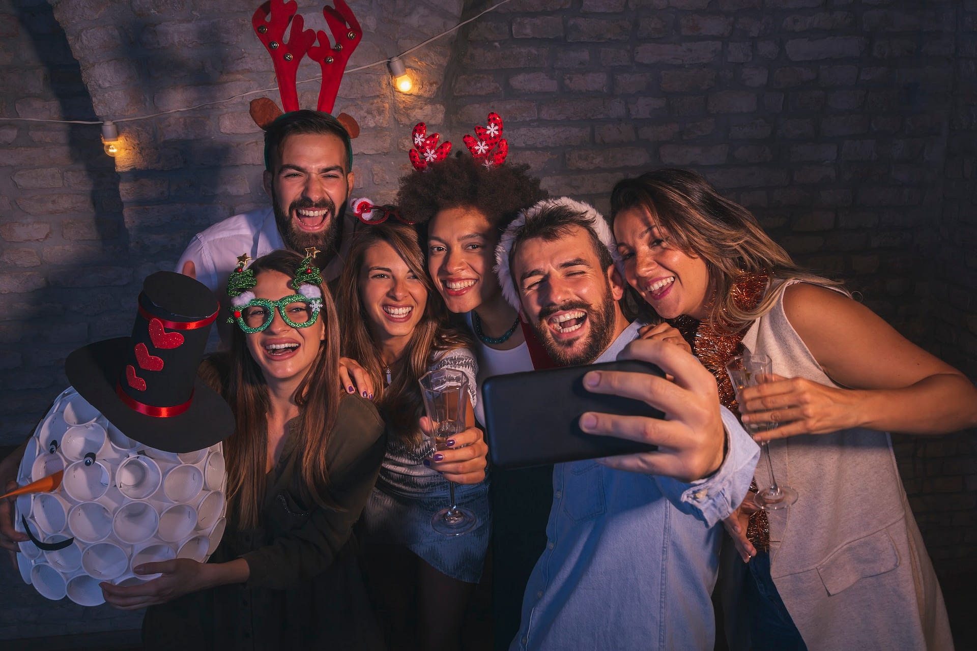 friends taking selfies at new year s eve party