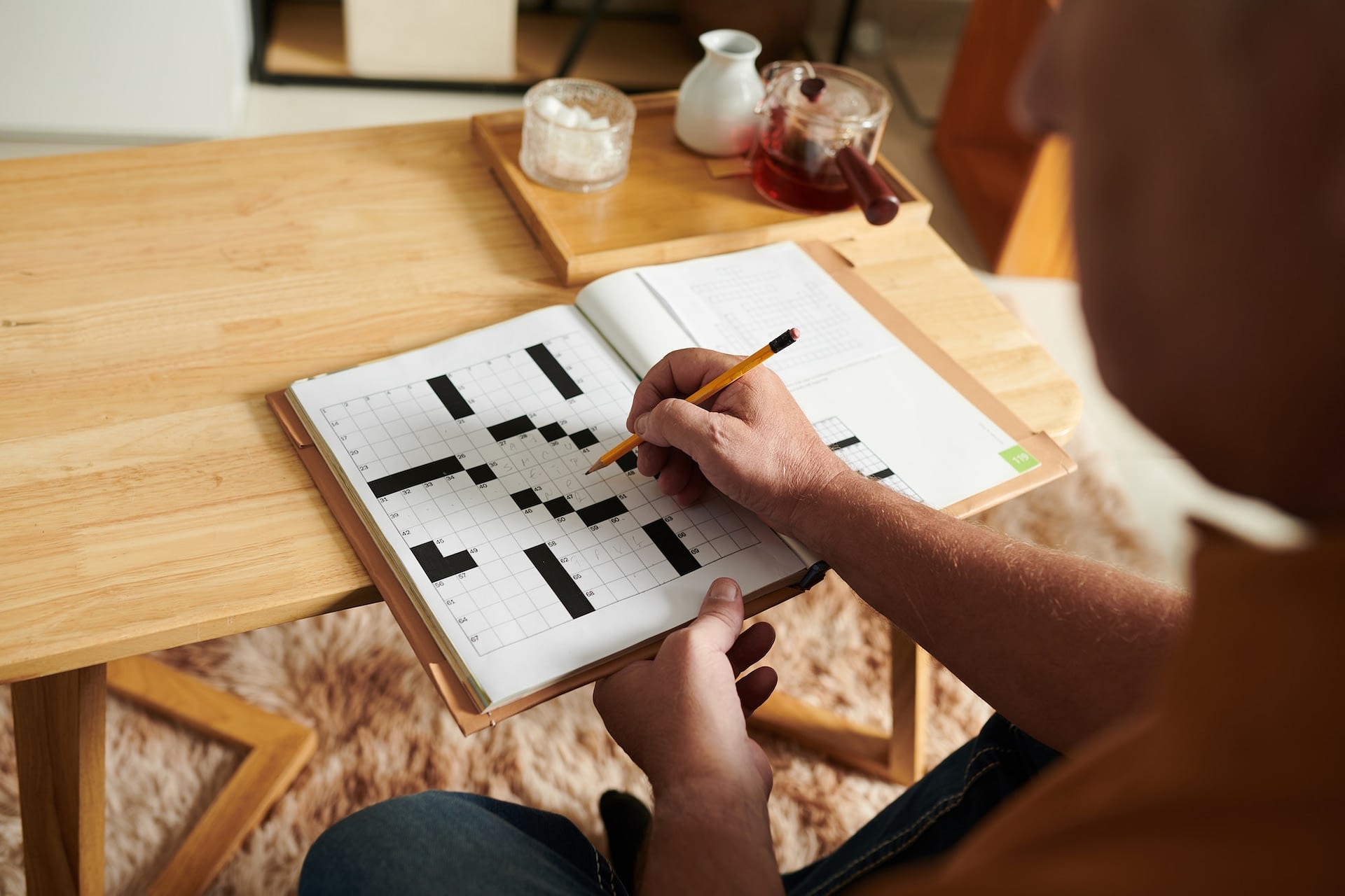 senior man solving crossword puzzle