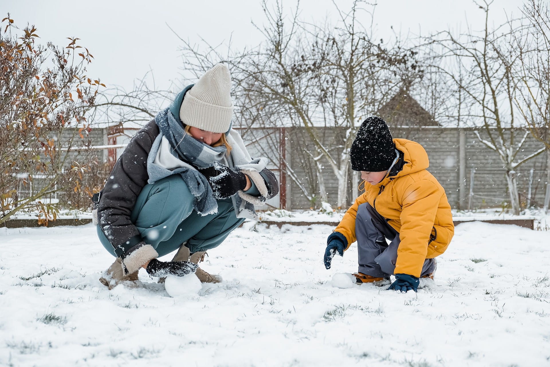 winter games family playing snowballs in the courtyard of the house winter game snow christmas