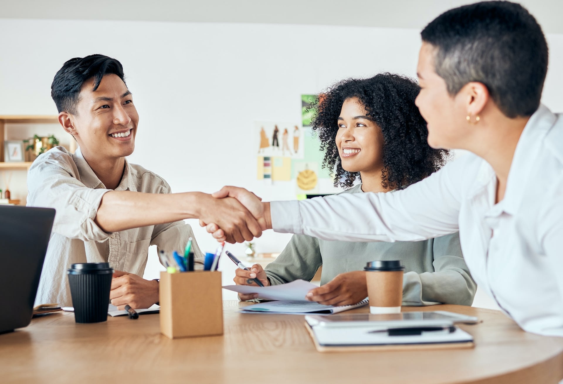 handshake global partnership and office deal in business meeting with man and women for diversity