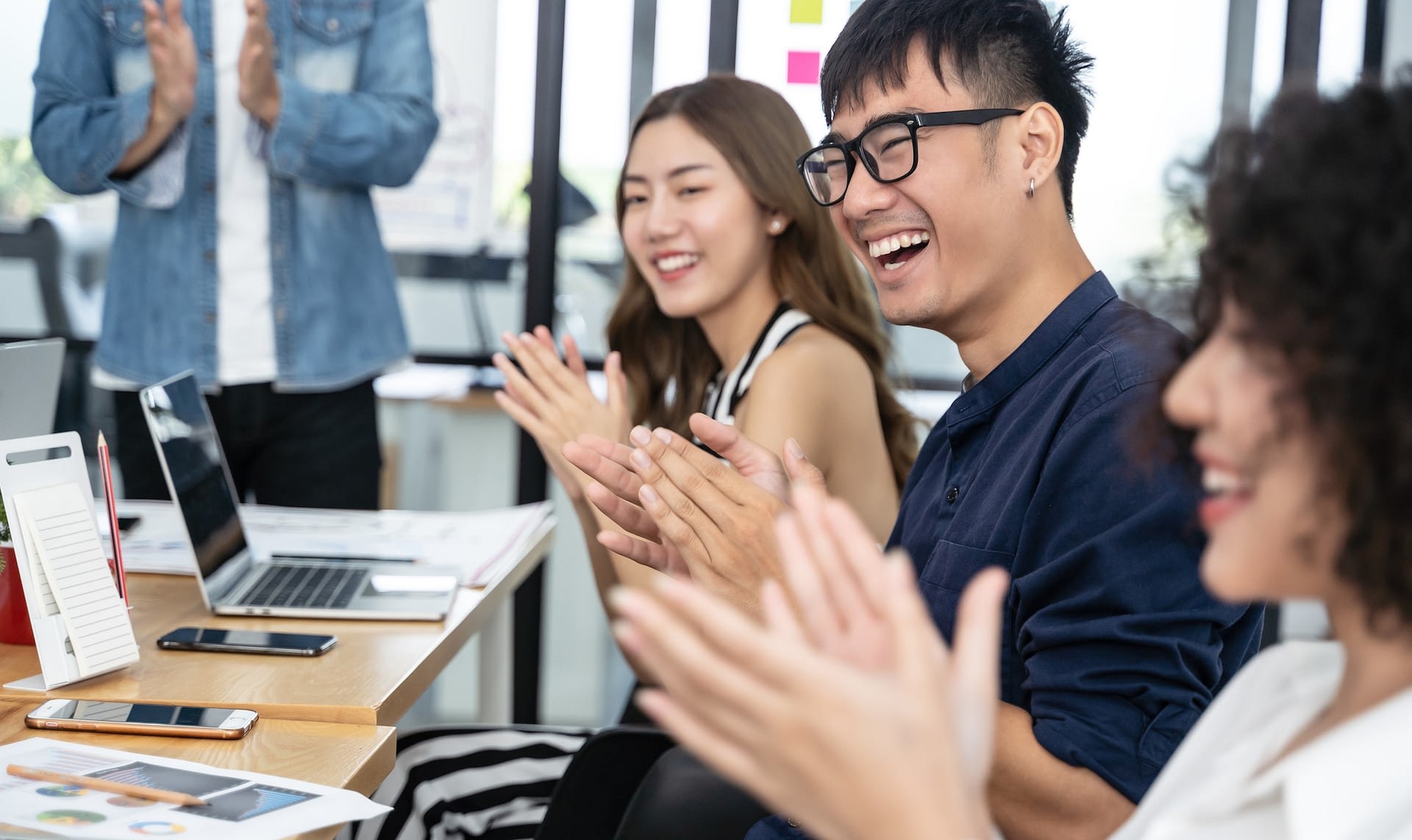 happy asian business clapping hands after business meeting