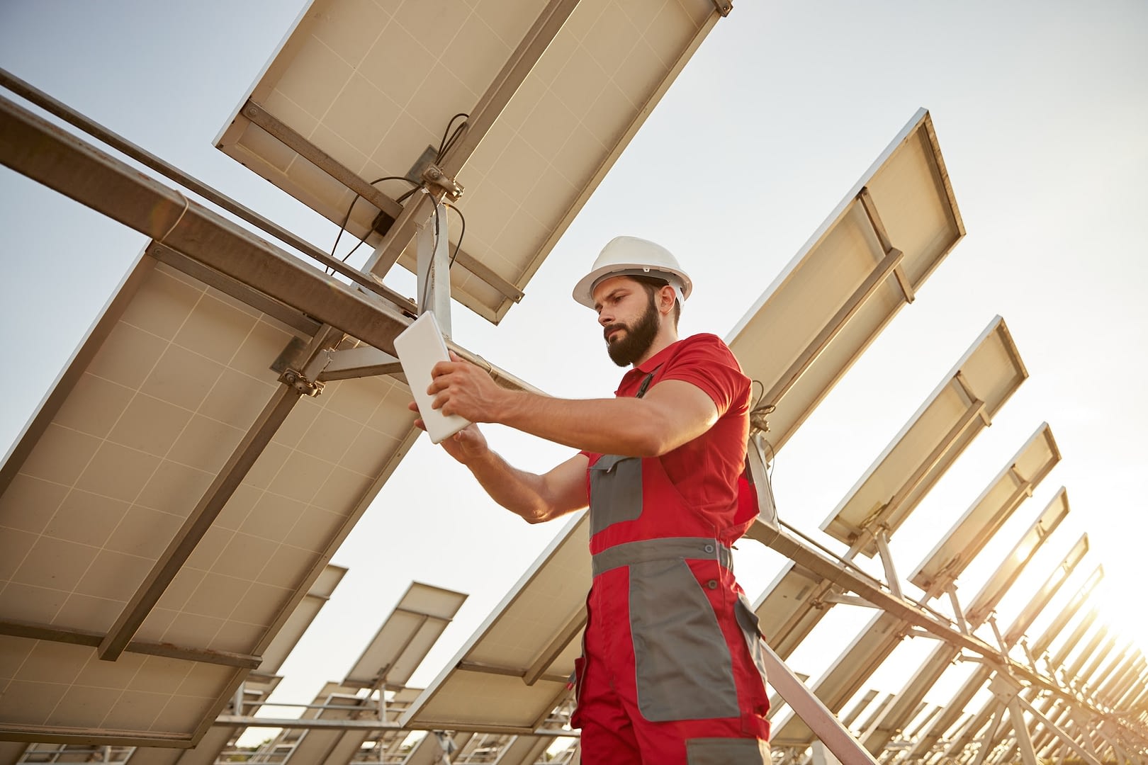 technician working in field with solar batteries