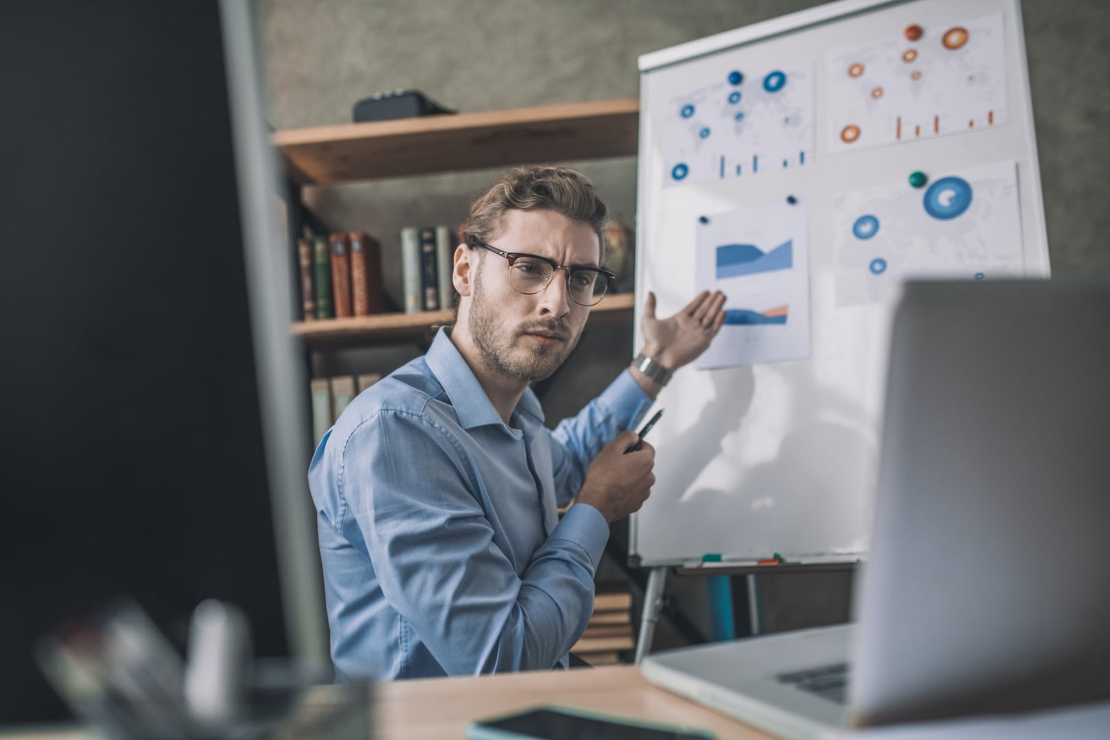 young bearded man in eyeglasses helding webinar