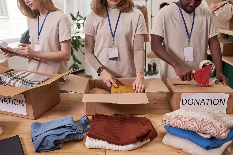 charity workers packing clothes