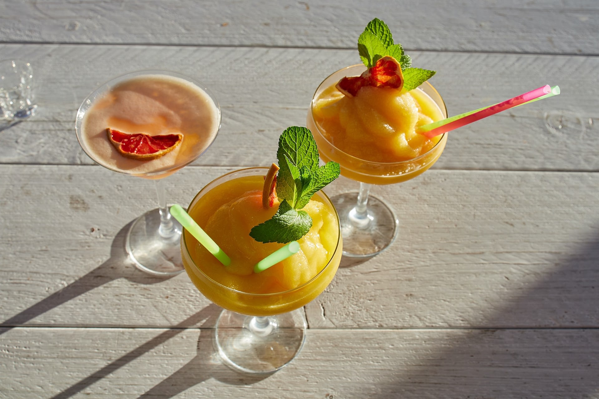 mango daiquiri cocktail in a white background on a sunny day mango daiquiri cocktail in a white background on a sunny day