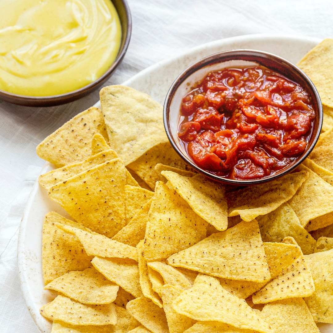 tex mex corn tortilla chips with cheddar cheese dip and salsa