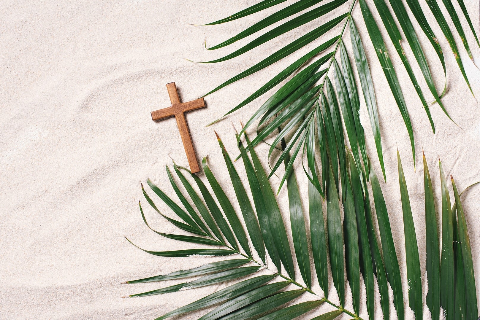 palm sunday concept cross made of palm and tropical leaves on sand background christian moveable