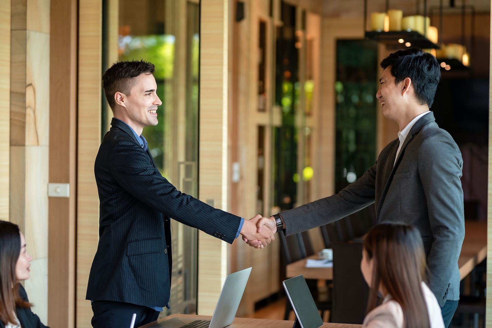business people collaboration deal shaking hands at meeting