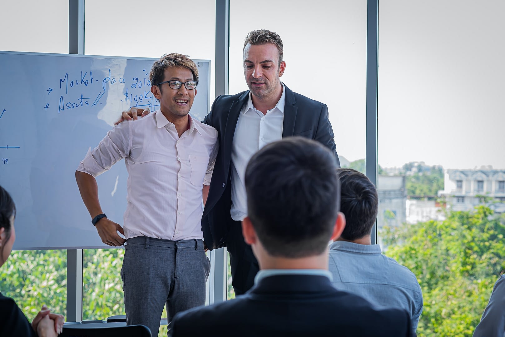 business team leader introduces new asian employee