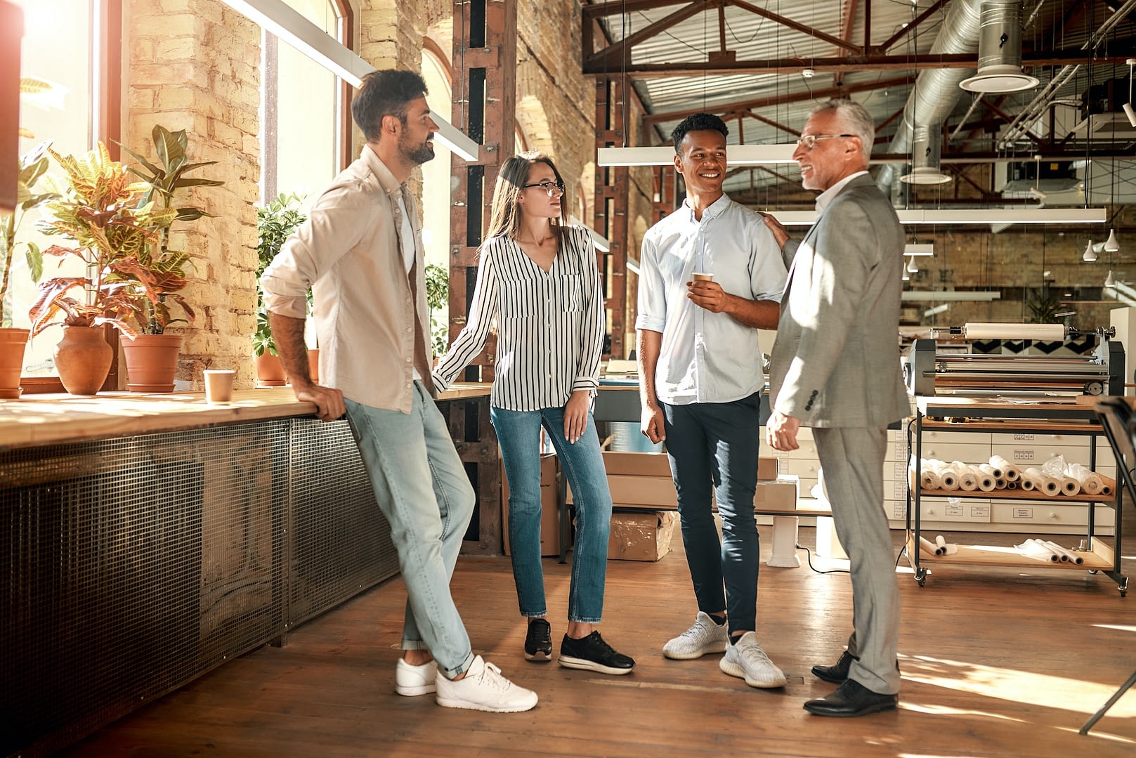 well done cheerful mature man in formal wear patting his young afro american colleague on shoulder
