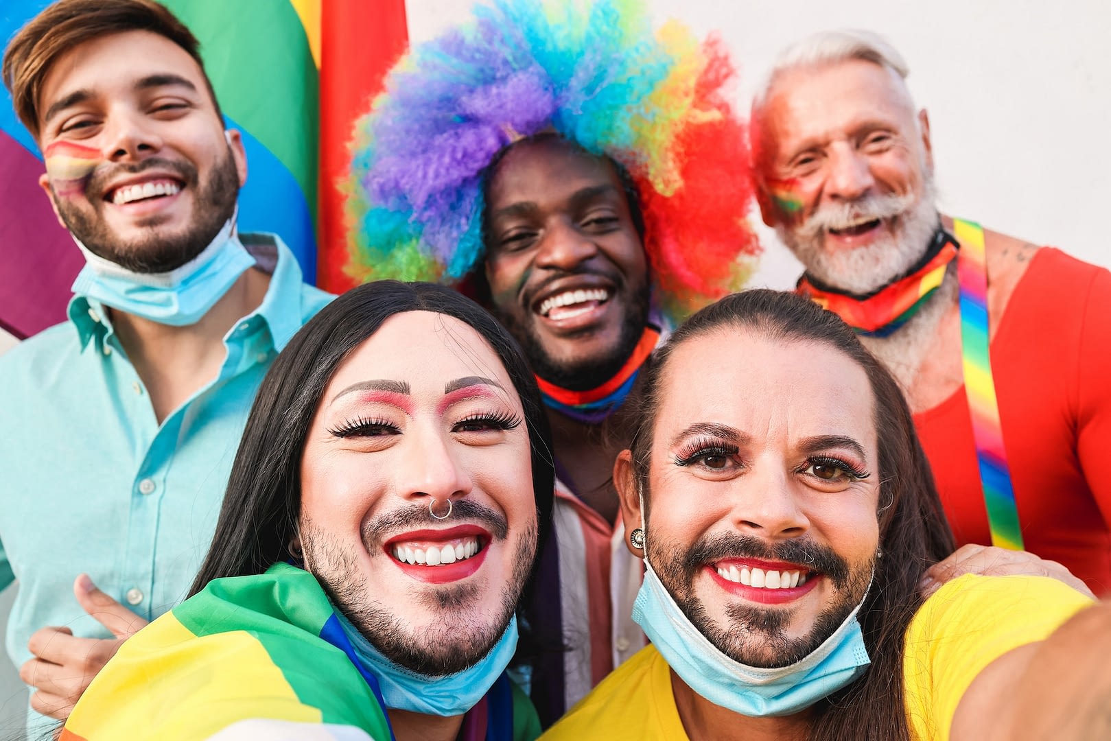group of friends taking a selfie at lgbt parade during coronavirus outbreak focus on transgender