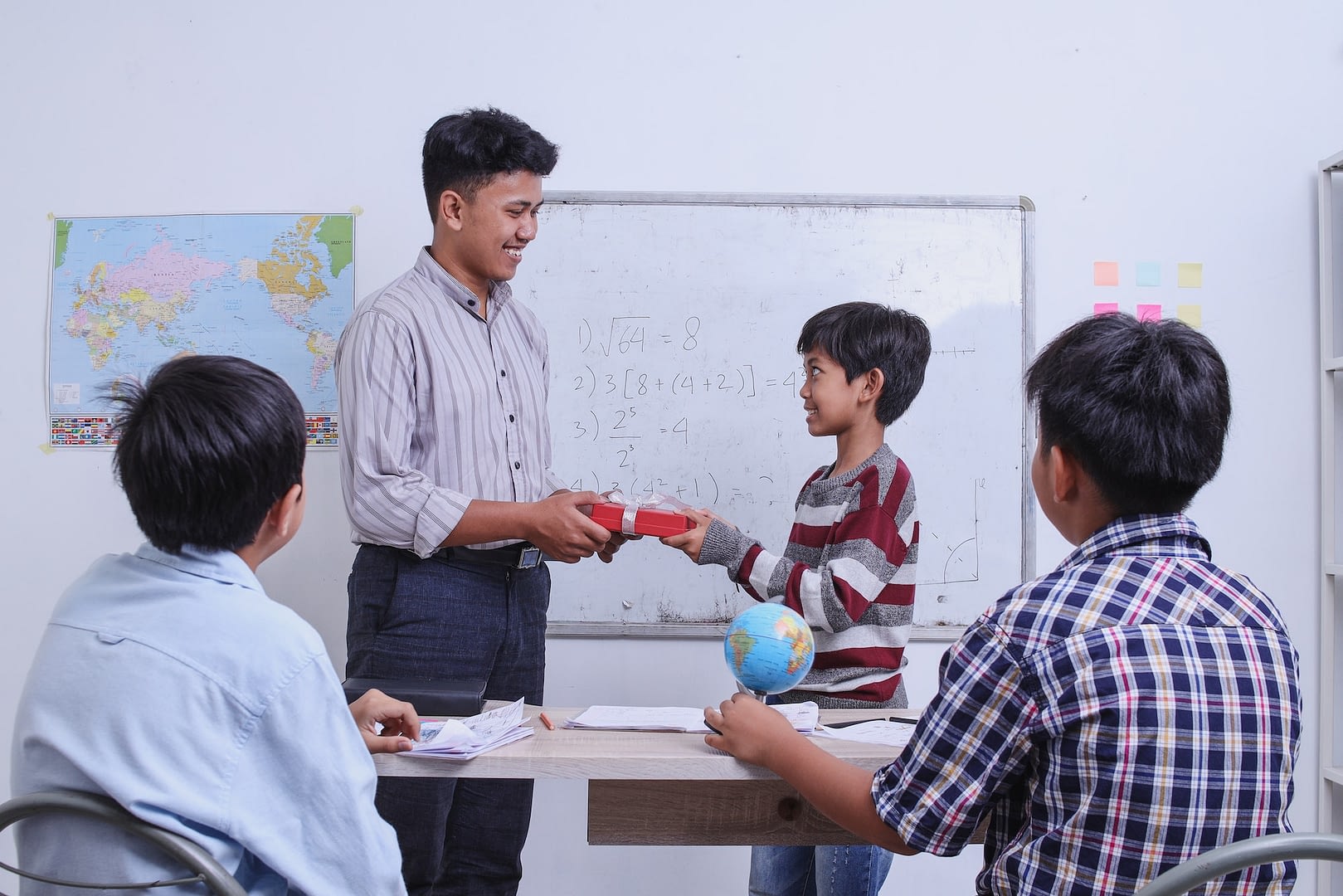 teachers day student presenting gift to teacher