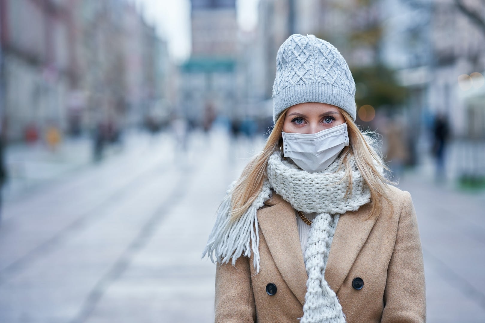 woman wearing face mask because of air pollution or virus epidemic in the city