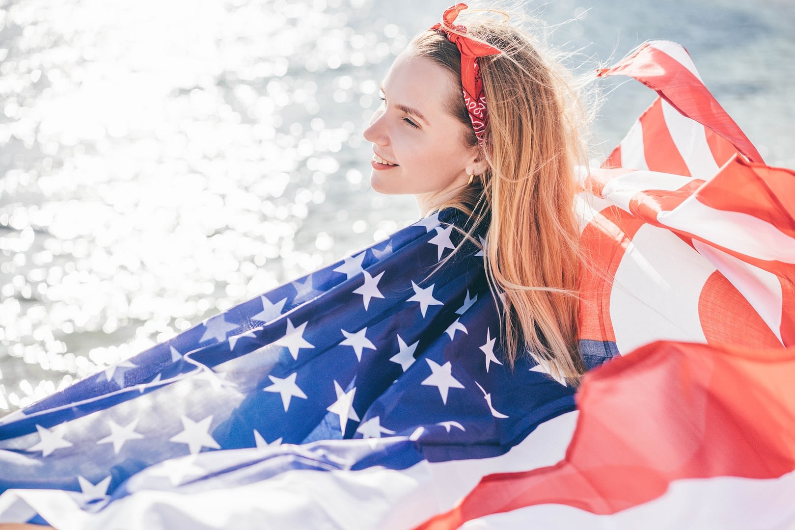 woman with american flag on the beach 4th of july independence day