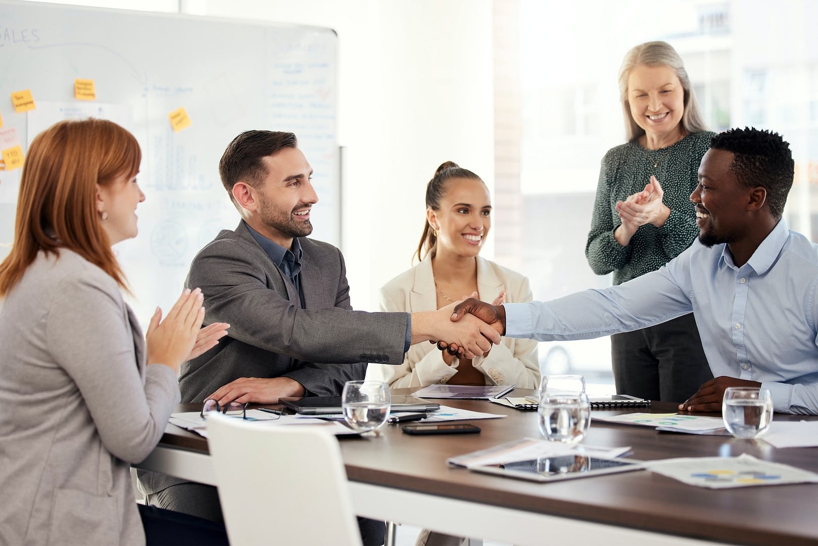 corporate client and partnership handshake of office workers with diversity in a business meeting