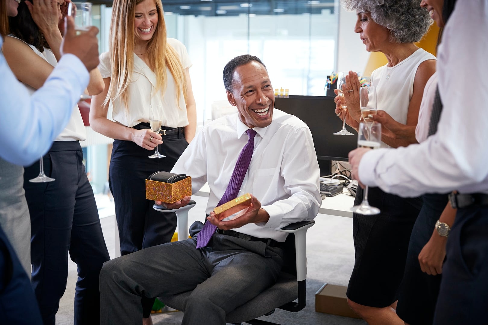 coworkers celebrating a colleague s retirement in the office