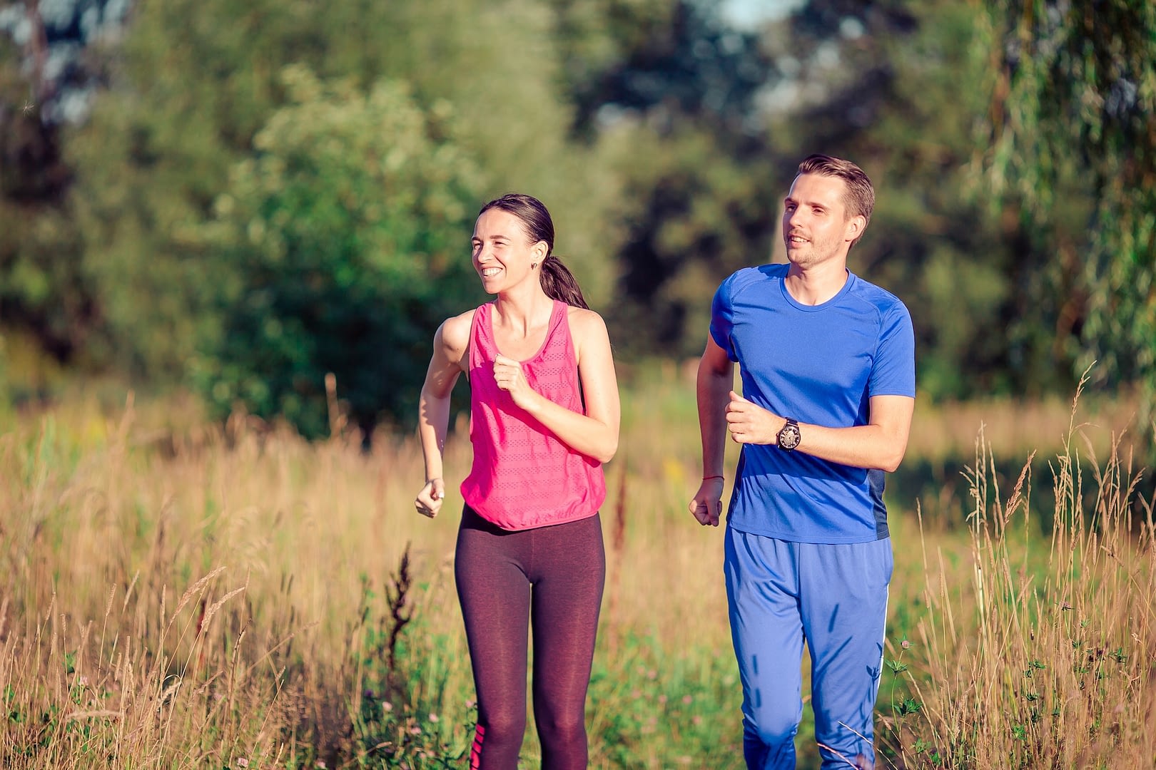 active sportive couple running in park health and fitness