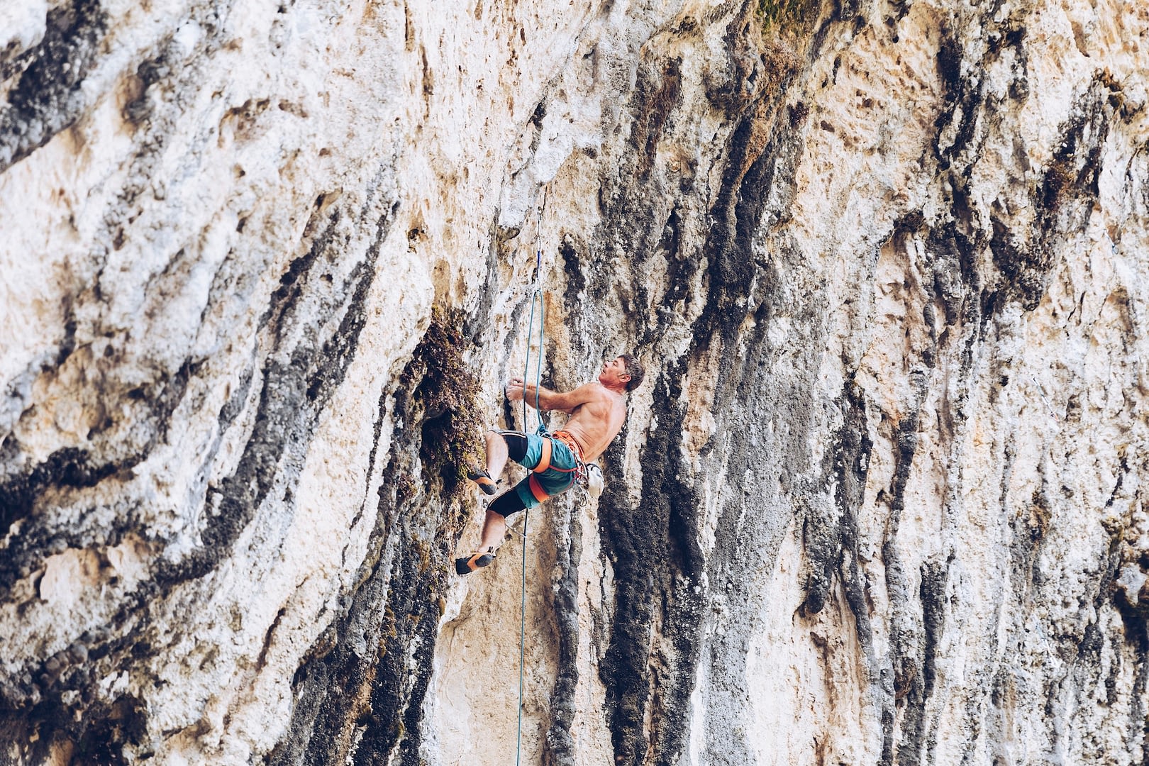 anonymous man climbing rock