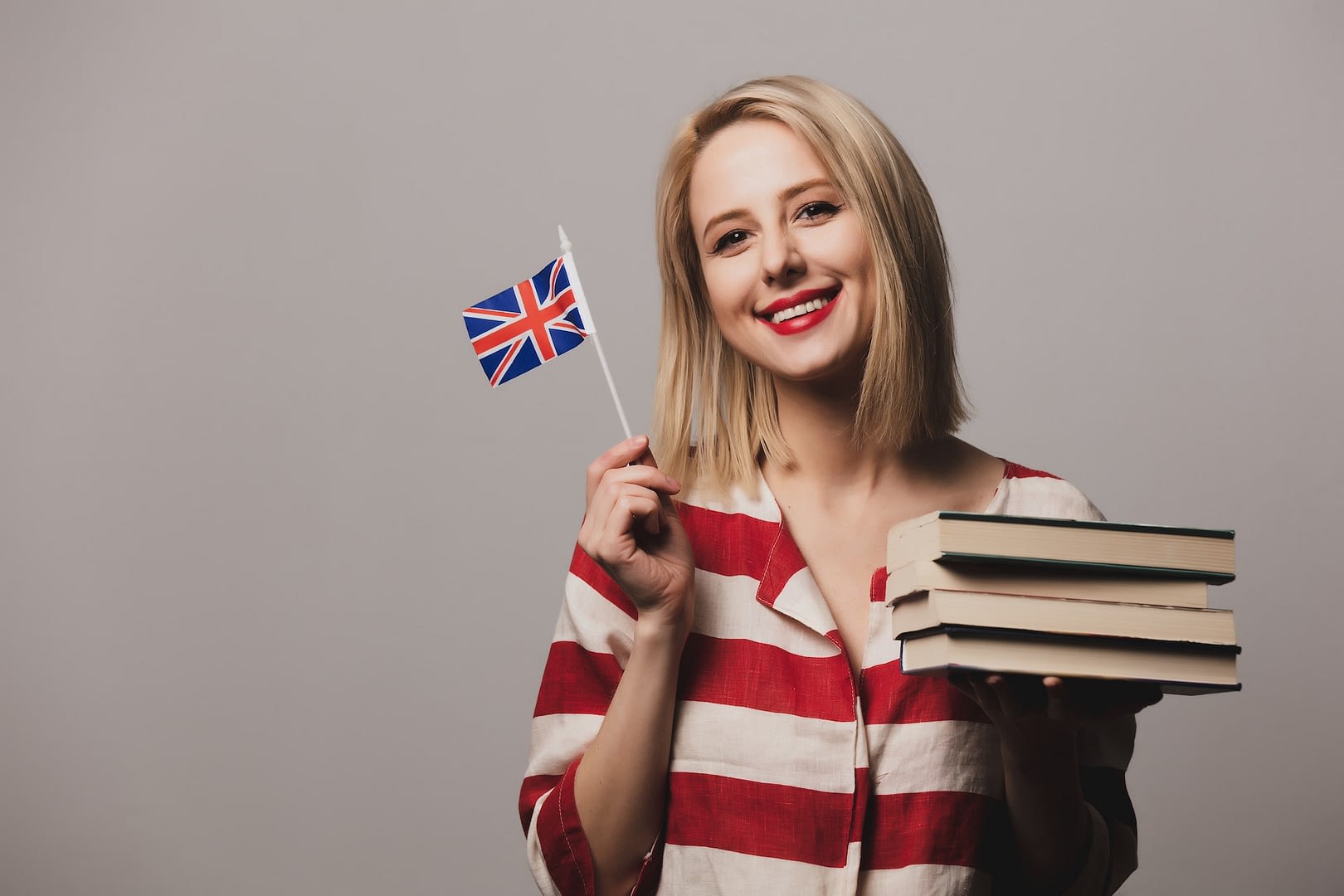 beatiful girl holds british flag and books
