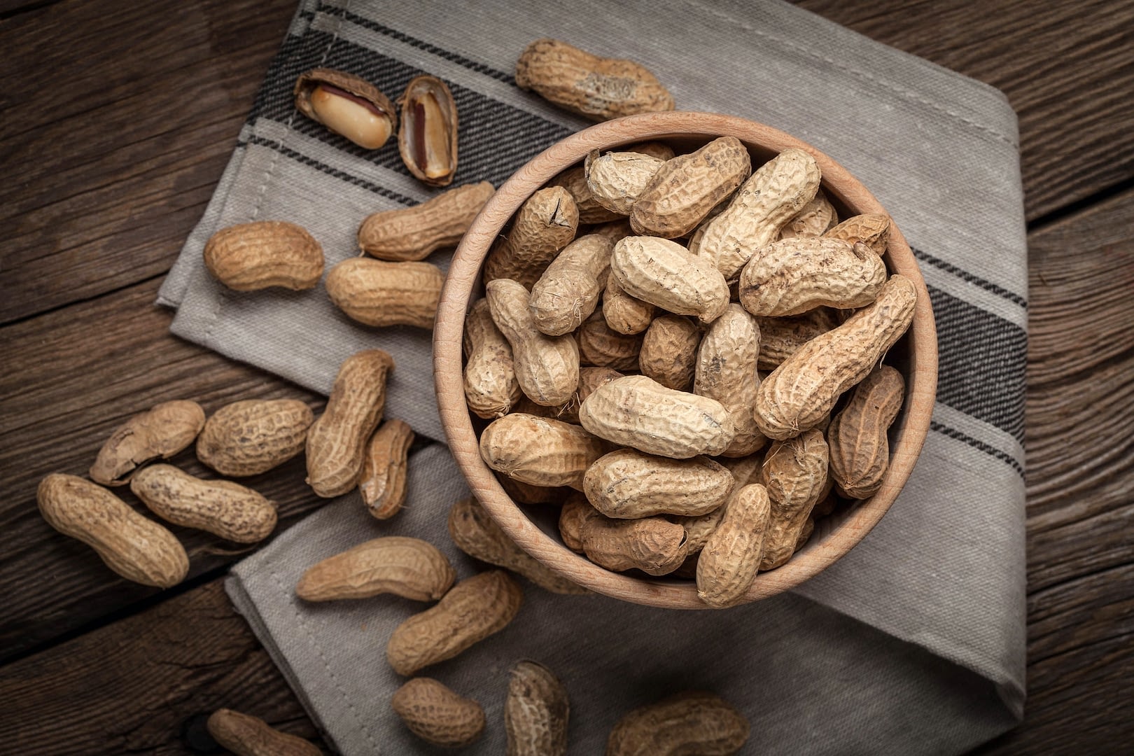 dried peanuts in wooden bowl