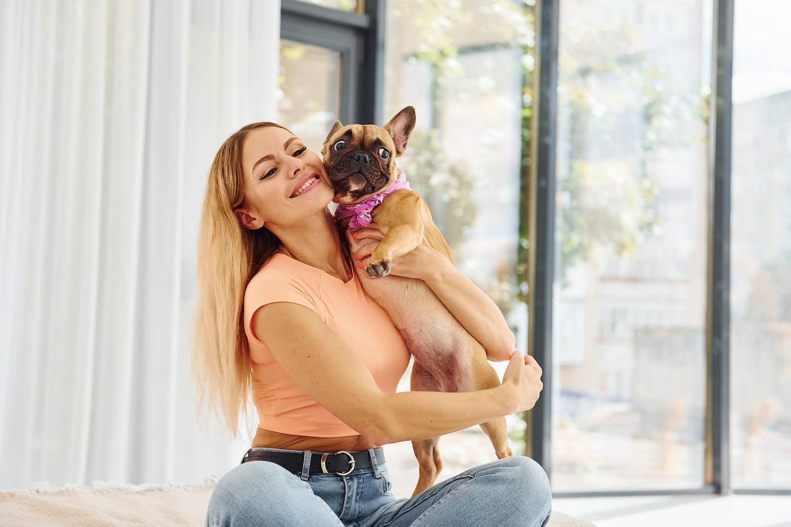 embracing the pet woman with pug dog is at home at daytime
