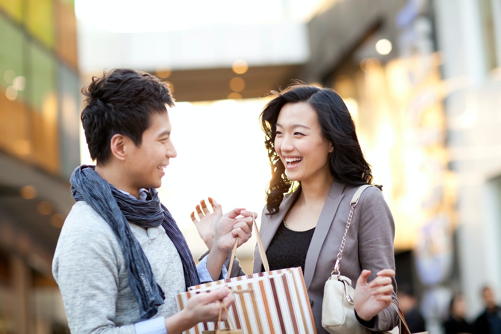 excited young woman receiving a surprise gift from boyfriend