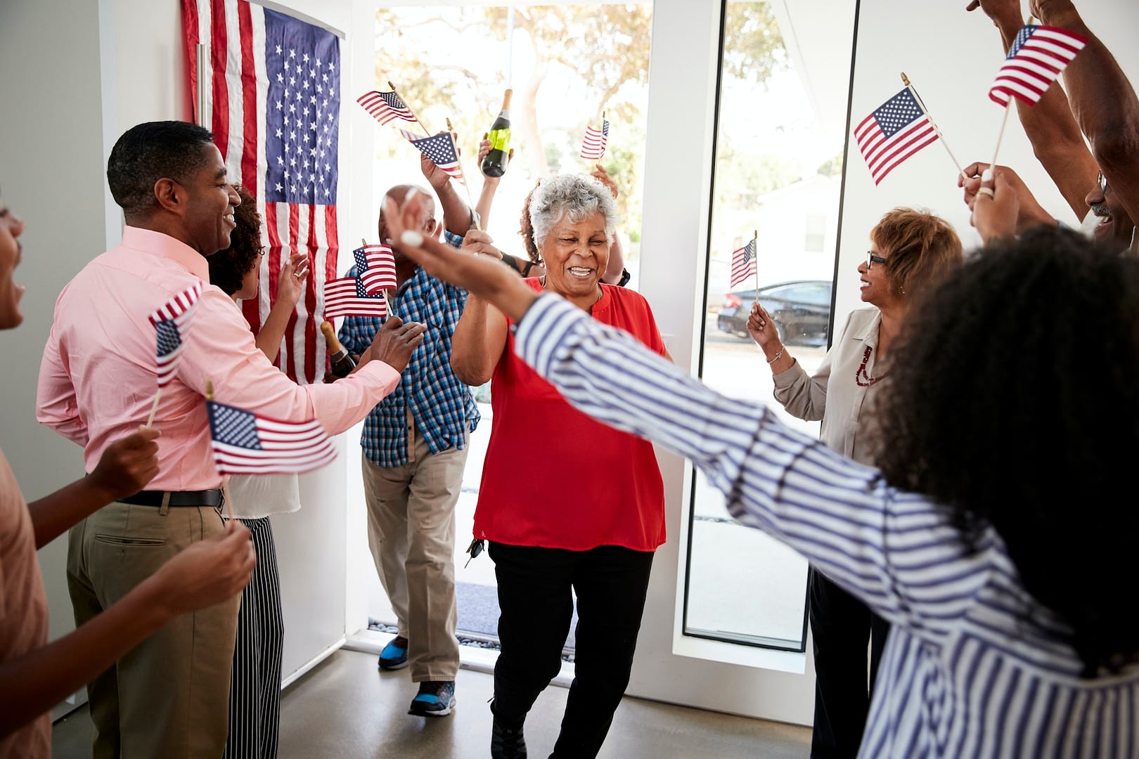 grandparents arriving at a three generation black family independence day party
