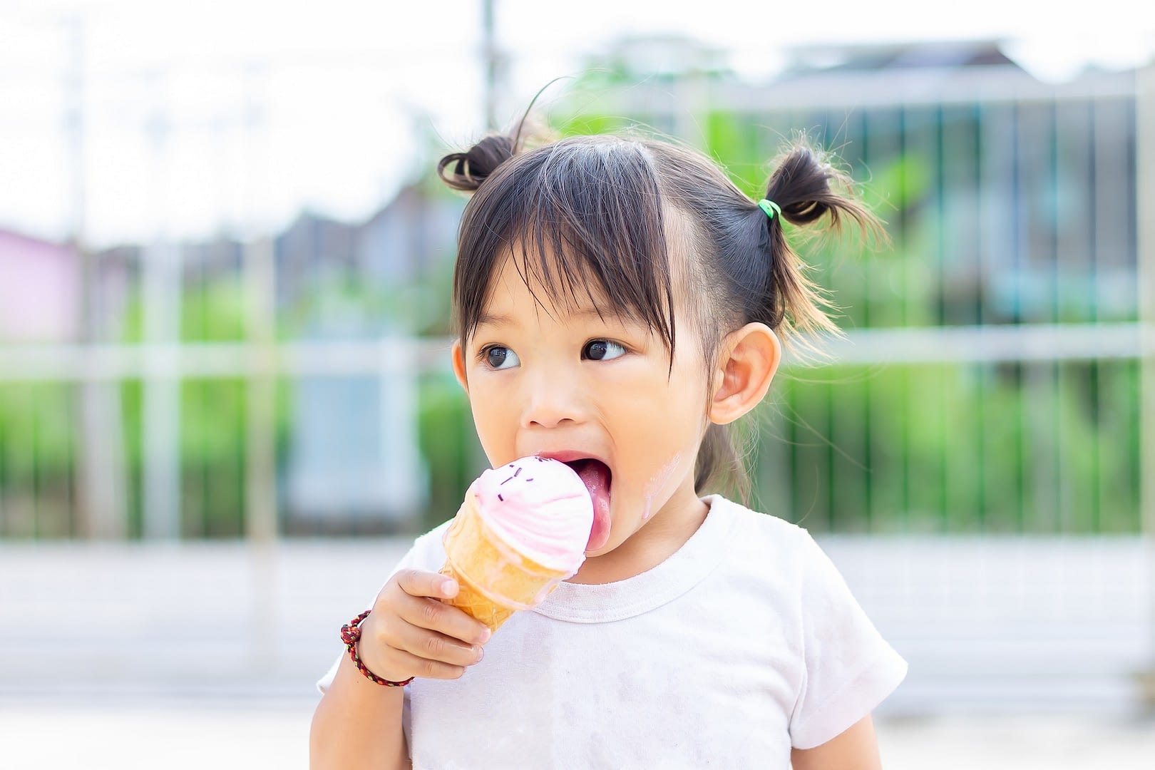 happy kid asian child girl eating an ice cream in the summer season national of ice cream day