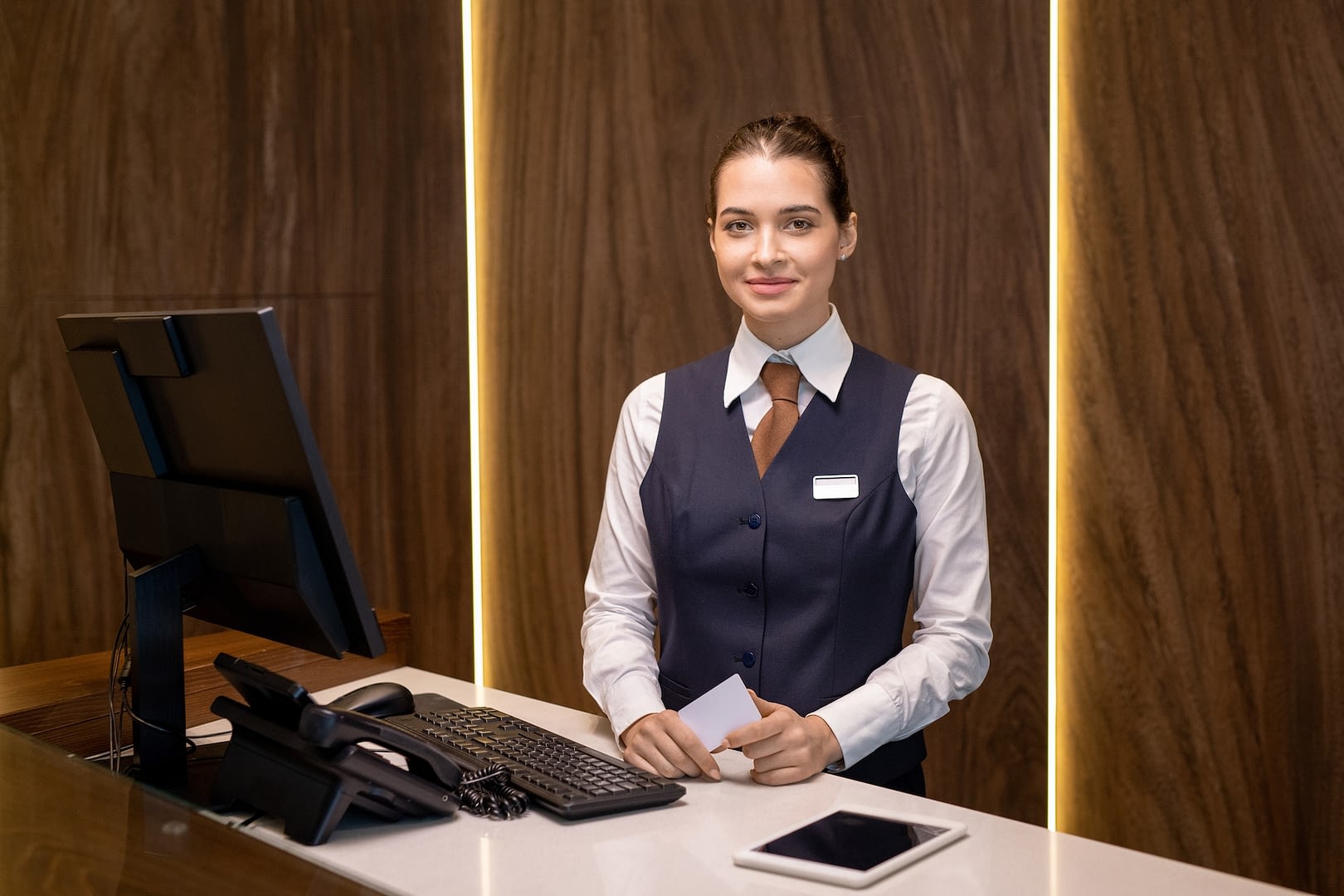happy young receptionist in uniform