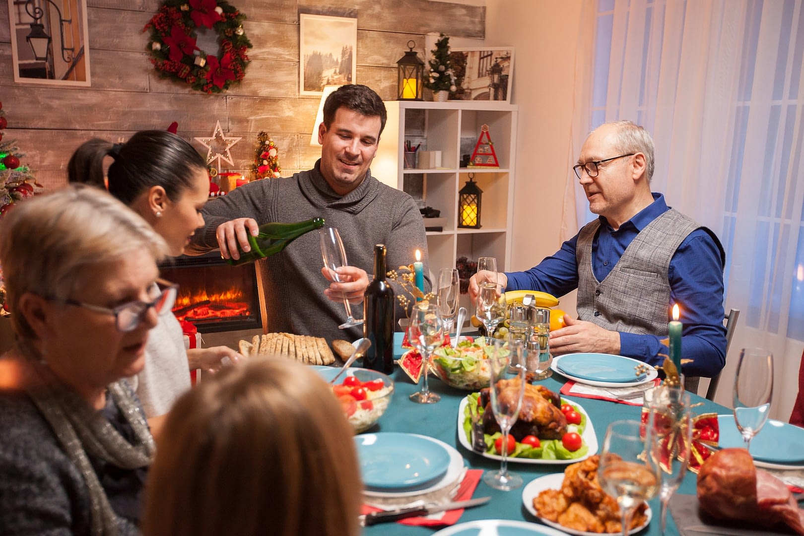 husband pouring wine for his father in law
