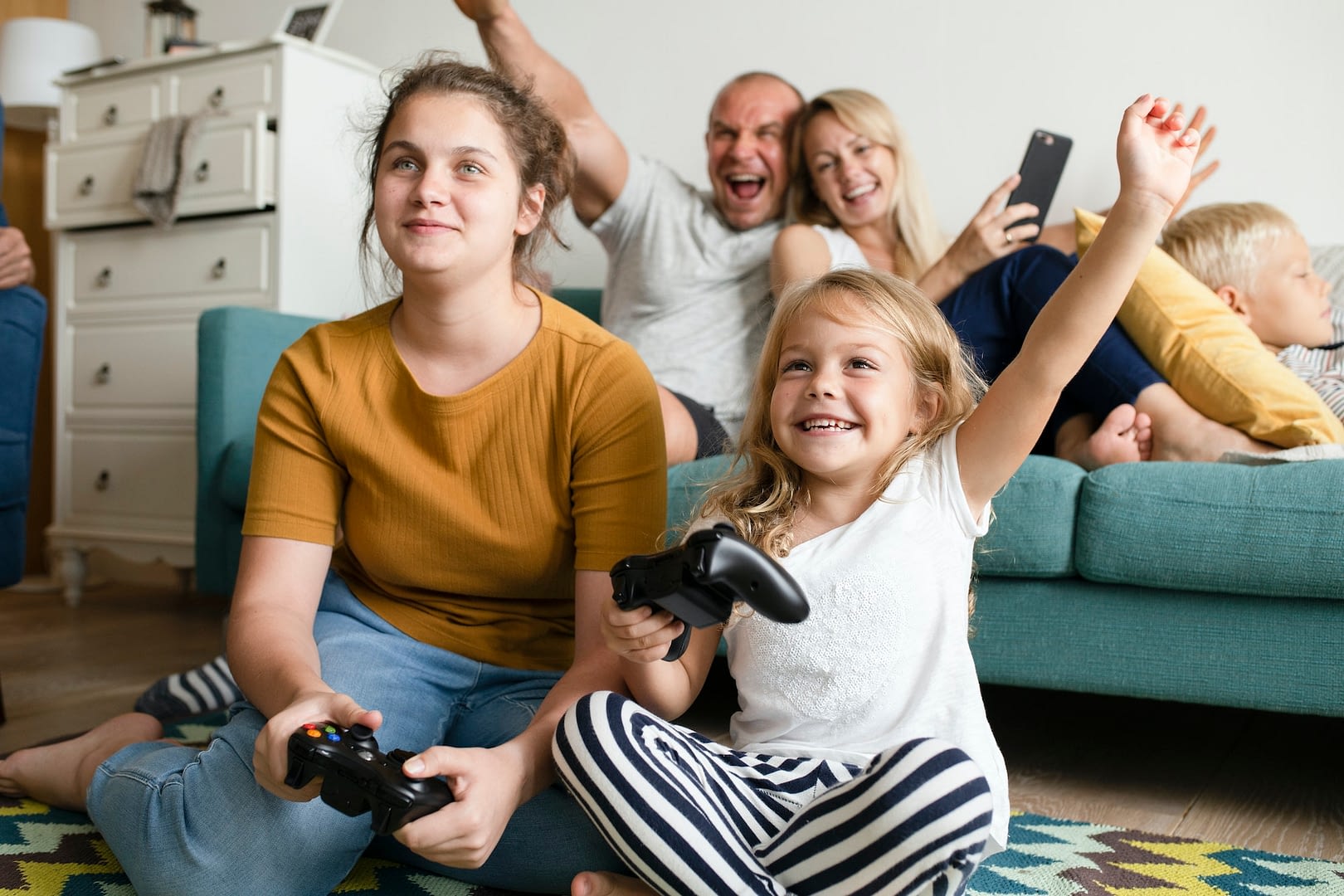 sisters playing a video game on the floor