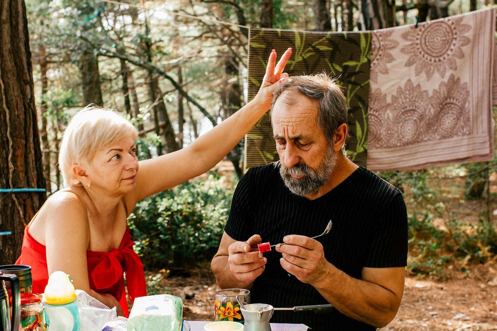 two senior citizen are relaxing in nature