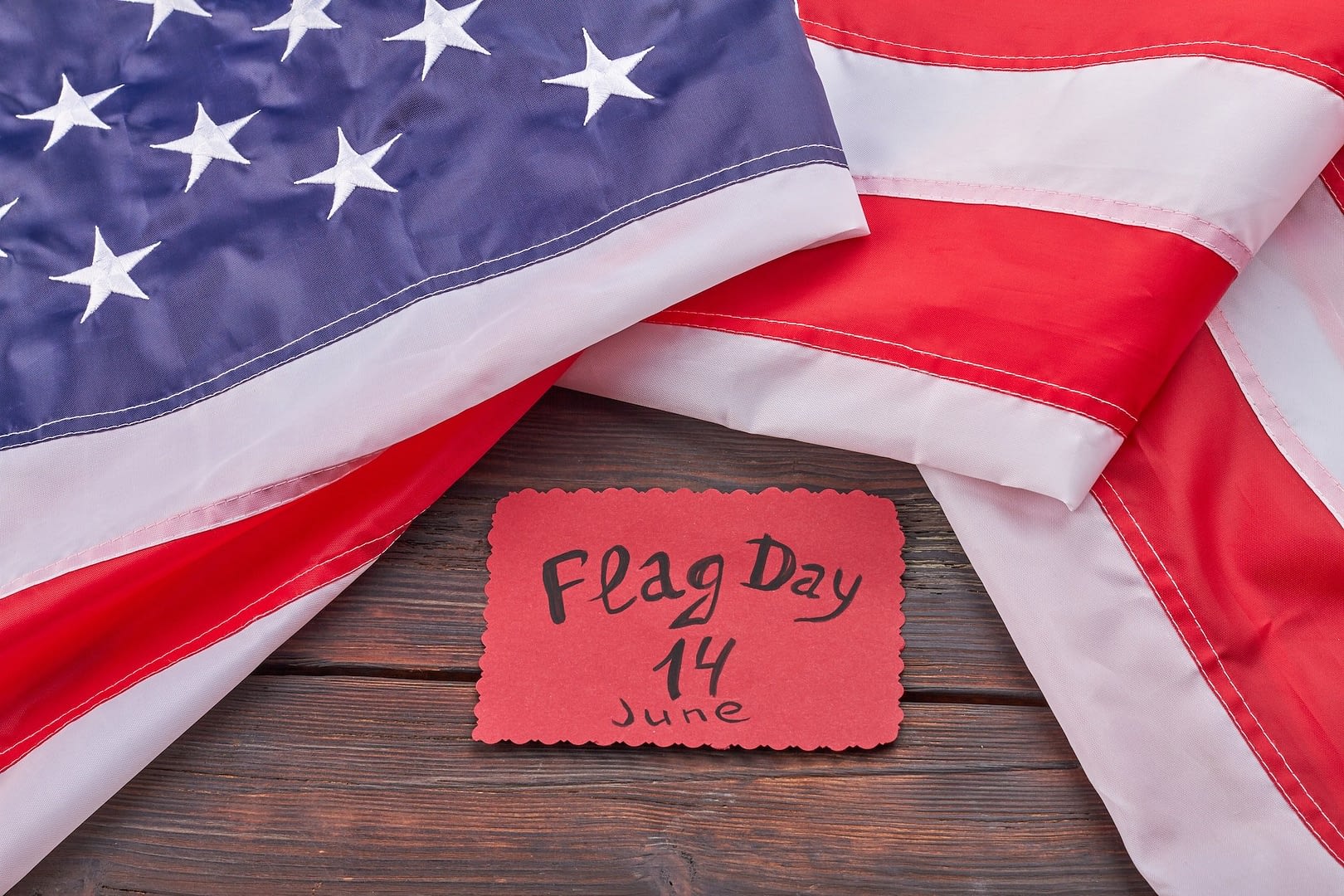 the united states flag day 14 june on wooden desk