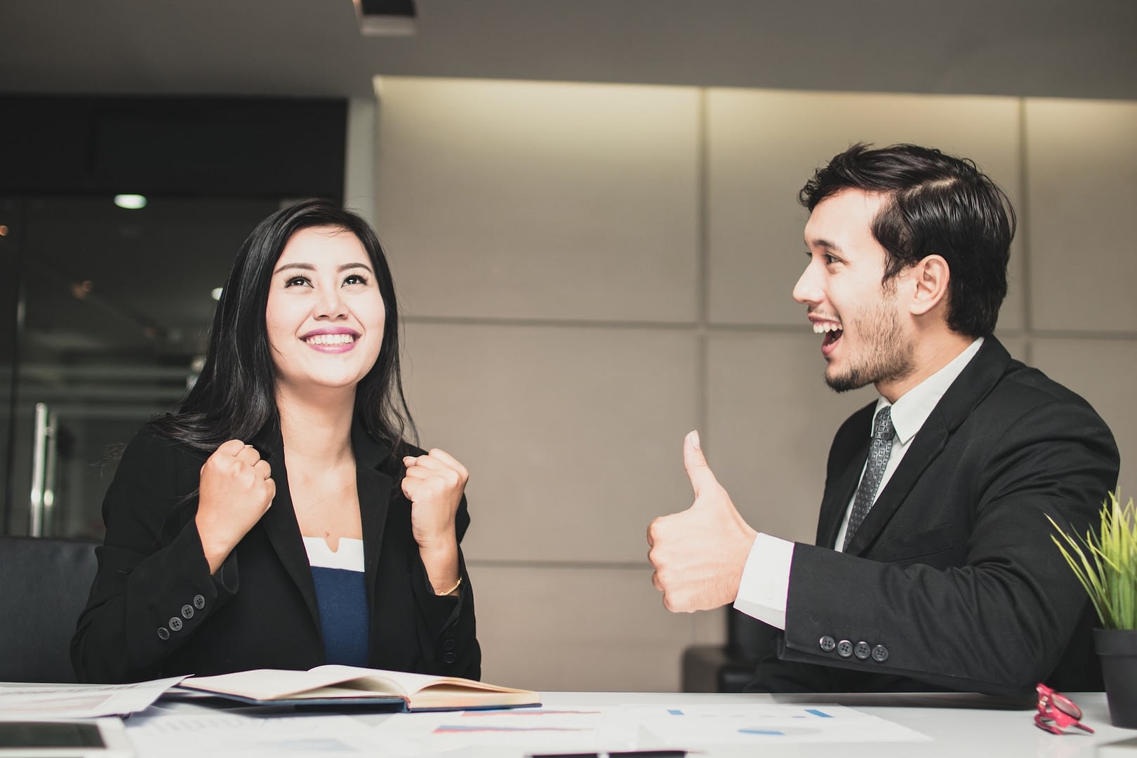 asian business woman celebrate and business man admiring for successful work