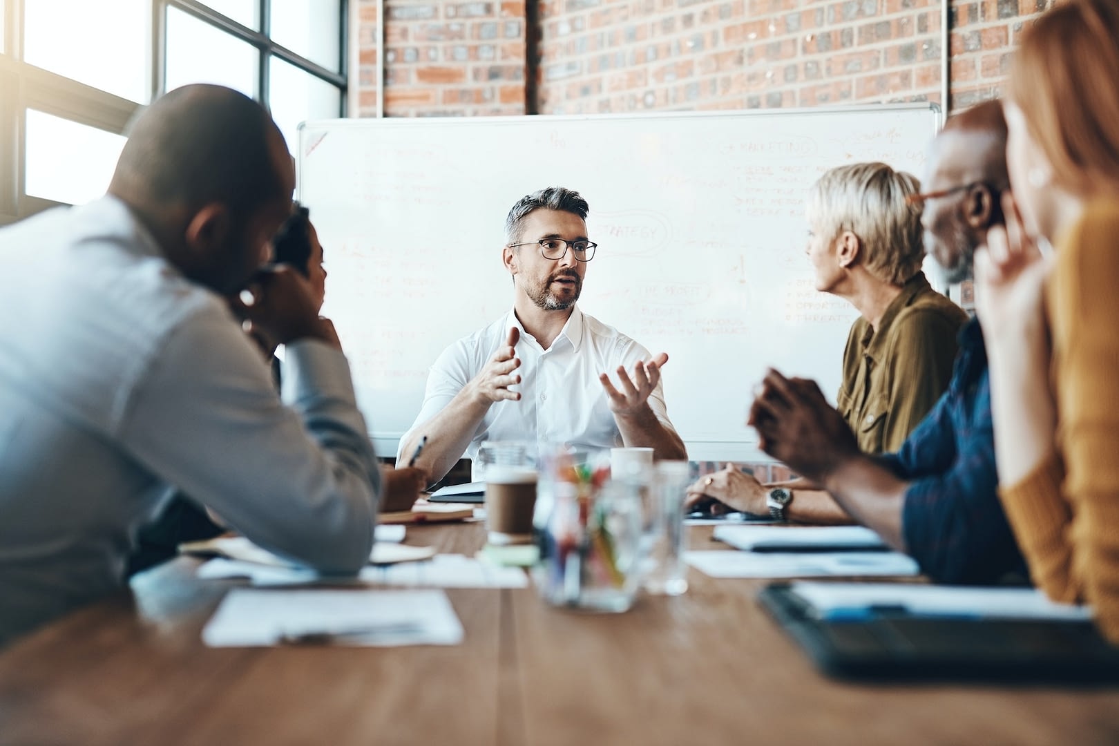 debating before reaching a decision shot of a businessman leading a meeting in the boardroom