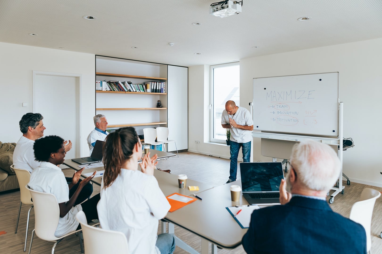 doctors applaud their colleague at the end of the meeting