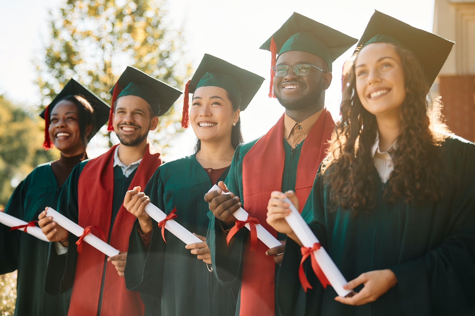 multiracial group of happy students on their graduation day