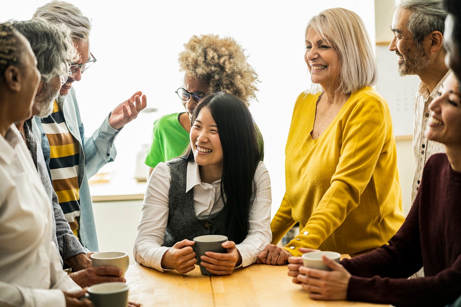multiracial happy friends having fun drinking coffee in kitchen family dinner friends party