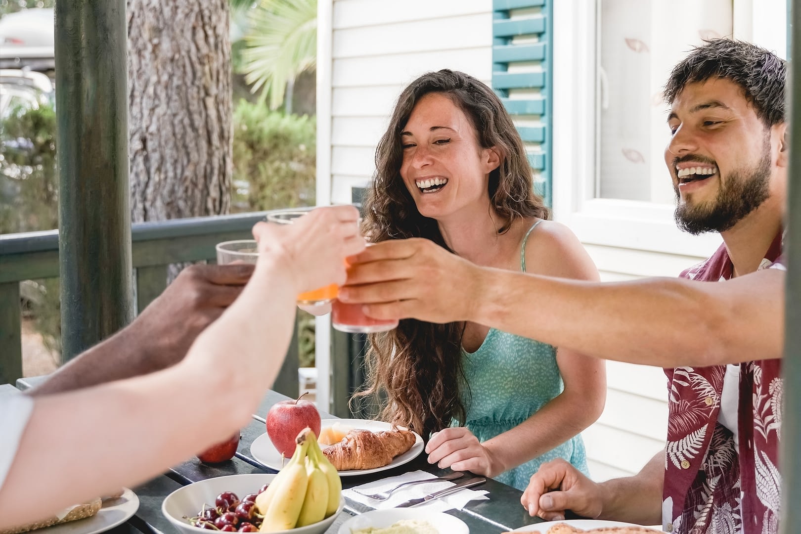 multiracial people doing healthy breakfast picnic party having fun eating together at countryside