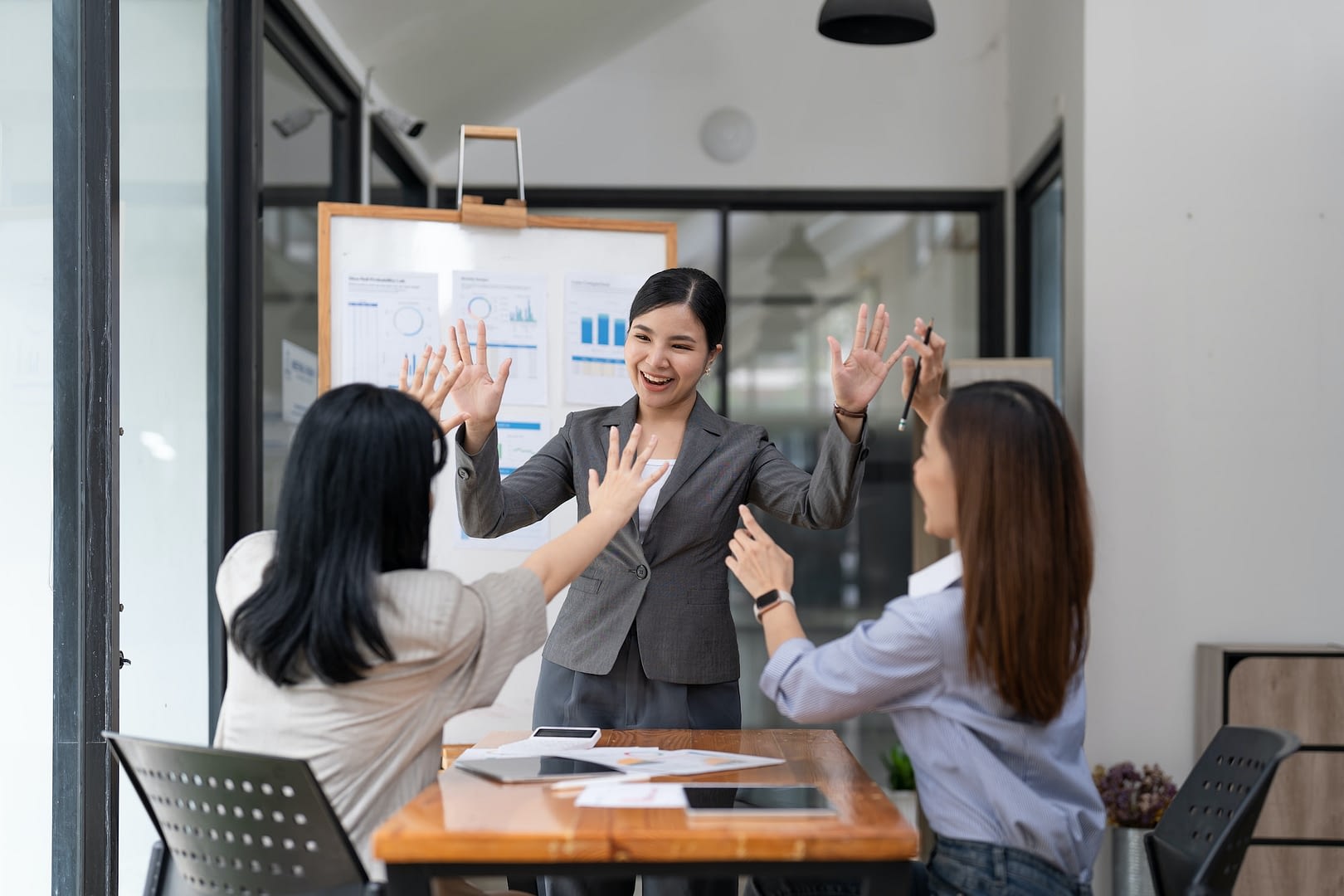 successful entrepreneurs and business asian people woman achieving goals celebrating achievement