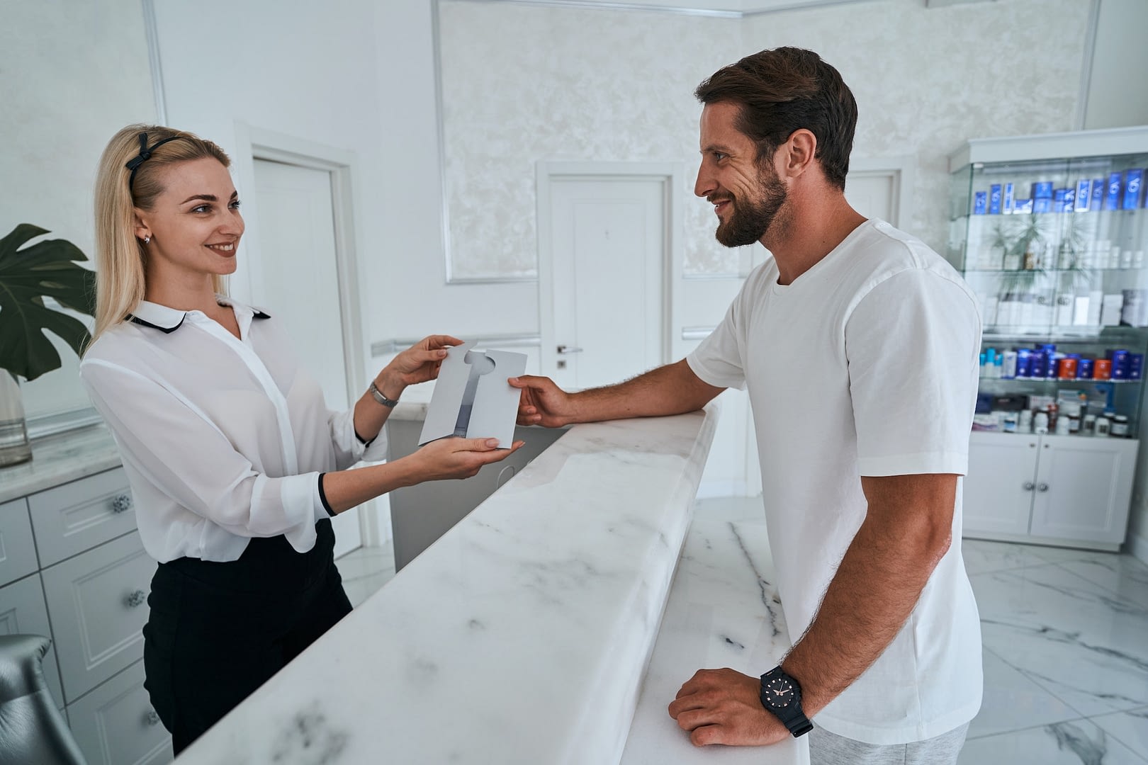 visitor getting a gift certificate from a spa employee