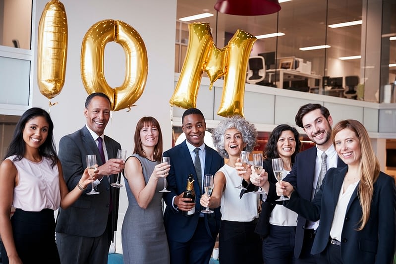 business people celebrate meeting target in the office