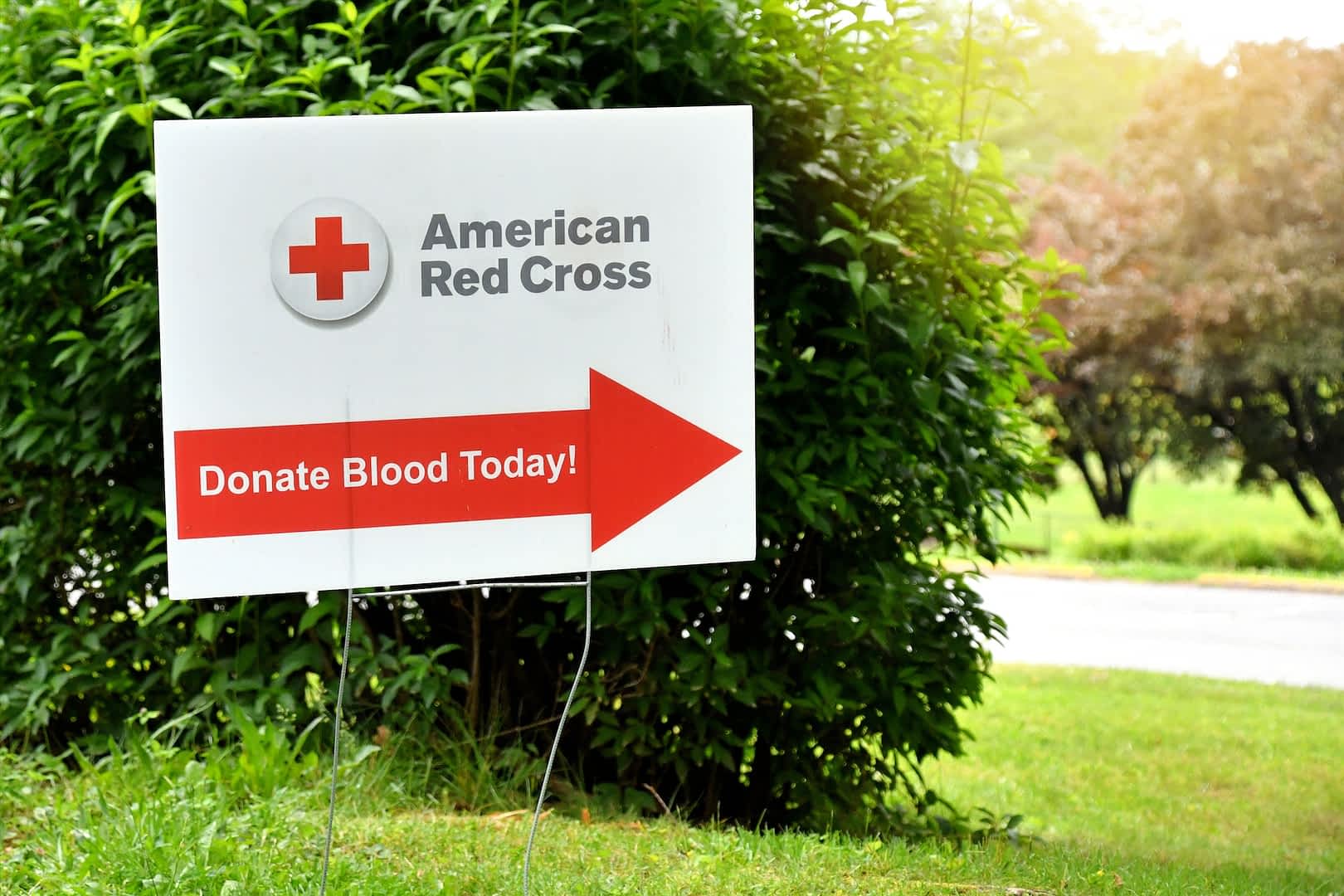 Blood drive, American Red Cross, Donate Blood Today sign pointing to donation site, blood donors