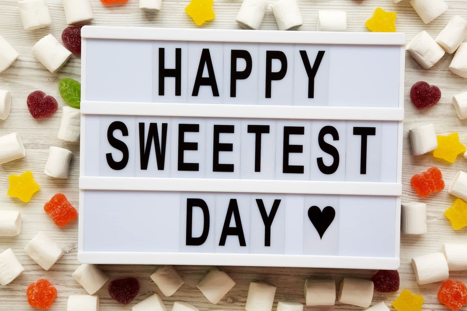 Modern board with text 'Happy Sweetest Day' word and candy