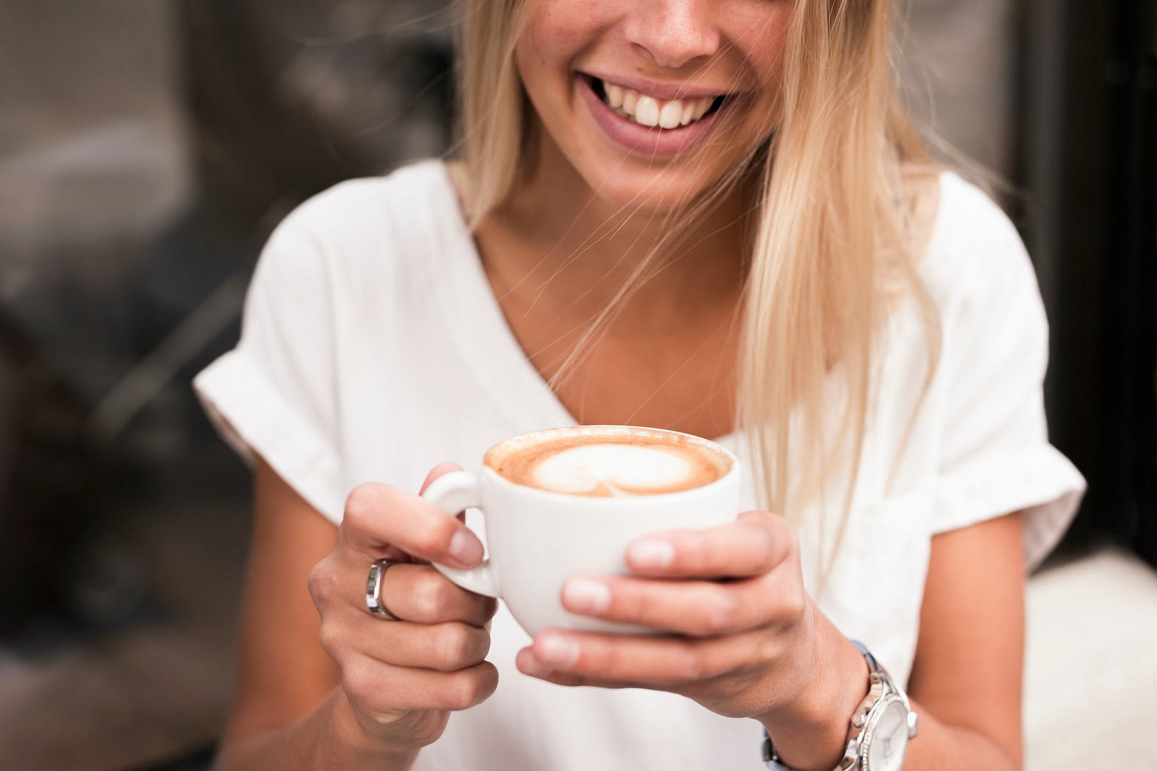 smiling woman with cappuccino