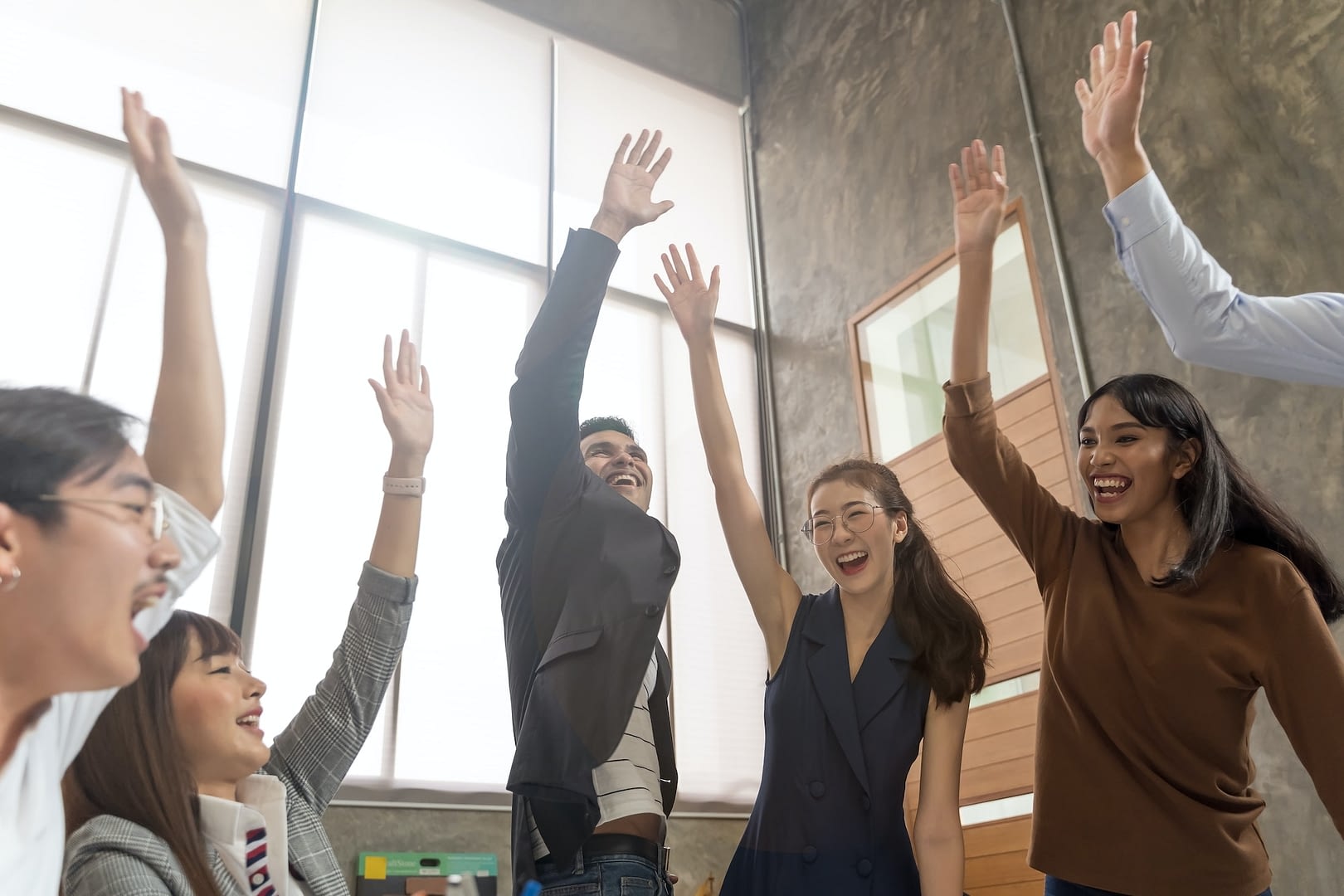 group of asian team creative business people join hands partnership teamwork concept